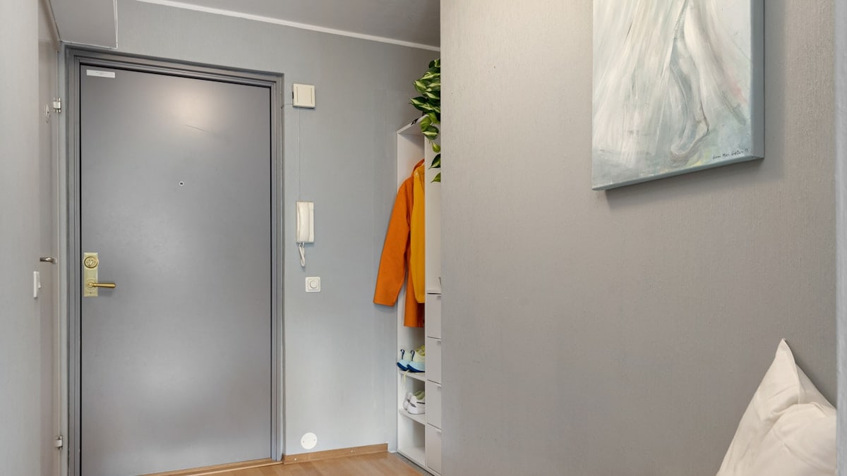 A hallway with a couch and a painting on the wall